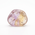 Representative ametrine tumbled stone on a white background
